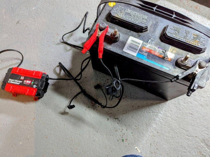 12 V automotive battery and battery charger. 12 V automotive battery and battery charger.